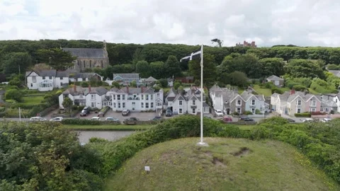 Drone orbital of the Cornish Flag flying in Bude, Cornwall, with the flag Stock Footage 279968001