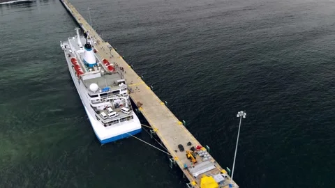 Drone orbiting around a docked ship at the dock. Video stock 169594547