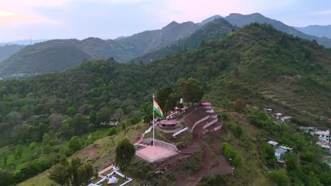 Drone orbiting around the Indian flag waving fearlessly atop a hill, a beacon of Stock Footage 311793654