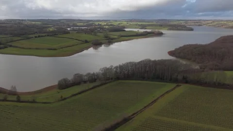 Drone orbiting around lake and farmland Stock Footage 328125665