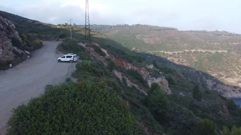 Drone orbiting camper van parked in wild camping spot, Elba, Italy Видео 336331204