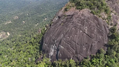 Drone orbiting giant rock formation from above with downward view 스톡 동영상 336956498