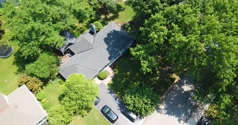 Drone Orbiting High over Ranch House in Wooded Suburbs Stock Footage 202094530
