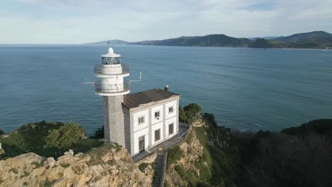 Drone orbiting the lighthouse of Getaria in Basque Country 스톡 동영상 334247967