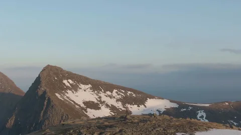 Drone Orbiting Lone Hiker on Another Mountain Summit In Lofoten Stock Footage 116430270