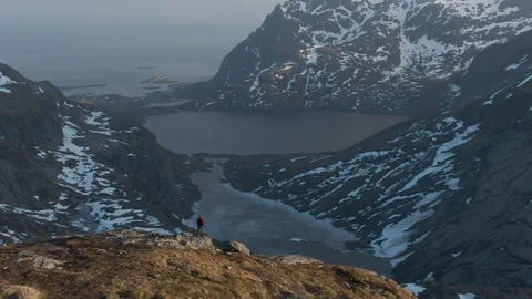 Drone Orbiting Lone Hiker on Mountain Summit In Lofoten Stock Footage 116430273