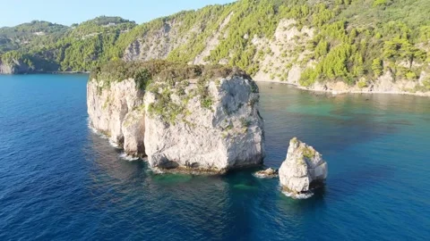 Drone Orbiting Majestic Rocky Islet Surrounded by Turquoise Mediterranean Waters Stock Footage 315073721