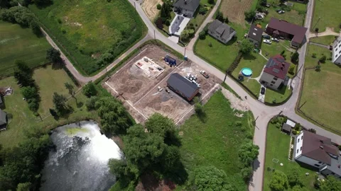 Drone orbiting a modern barn house construction site in a rural suburban area Stock Footage 347802094
