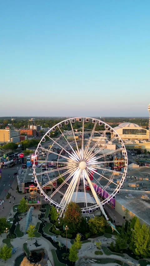 Drone Orbiting Niagara SkyWheel and Clifton Hill Entertainment District at Video stock 330450780