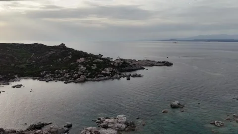 Drone Orbiting Stone Lighthouse at Sunset Over Mediterranean Sea Sardegn Vídeo Stock 333400052