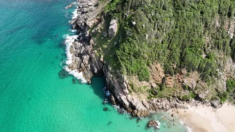 Drone orbiting wild rocky cape with crystal clear sea and visible seabed 스톡 동영상 336974605