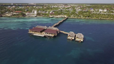 Drone orbits around large wooden cabana at the end of a pier Stock-Footage 346470871