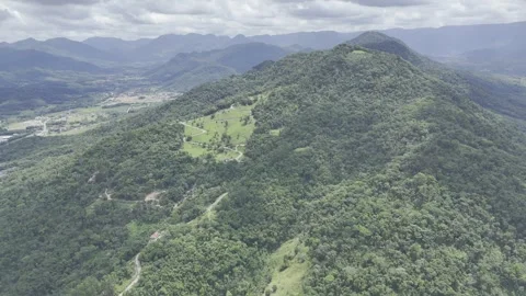 Drone orbits to the left around the top of Pico Malwee mountain Stock Footage 298108328