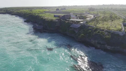 Drone orbits left around Usuma Rock restaurant during high tide Stock Footage 344117557