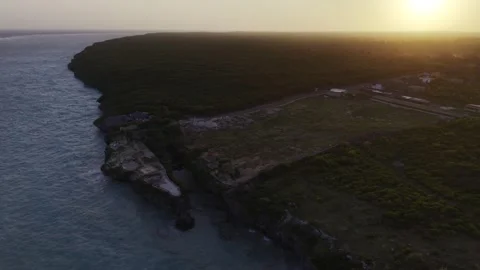 Drone orbits left high over Mtende Beach at high tide at sunset in Zanzibar Stock Footage 344140819