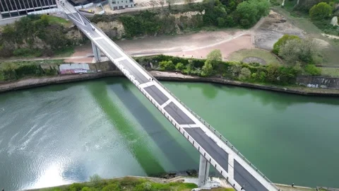 Drone orbits left over the Keel Crossing as sunlight reflects on the River Stock Footage 334572080