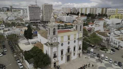 Drone orbits in a medium shot in front of 18th-century Catholic church Stock Footage 310364736