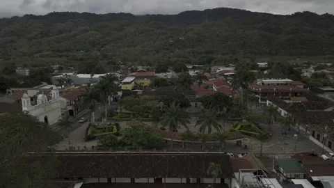 Drone orbits from the north to the west side of central park in downtown Copan Stock Footage 306615131