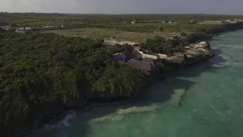 Drone orbits to right over Mtende Beach at high tide on a sunny afternoon Stock Footage 344119899