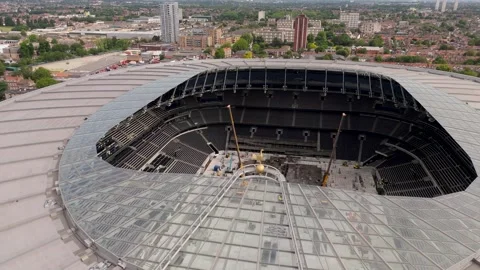 Drone Orbits Tottenham cockerel logo with concert stage setup below on stadium Stock Footage 310947739