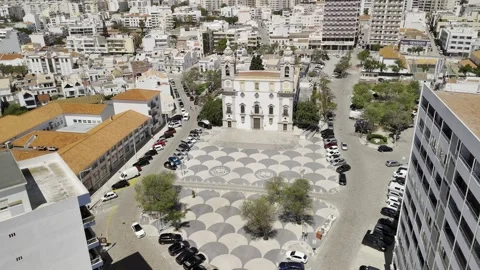 Drone orbits in wide shot on sunny day of 18th-century Catholic church Stock Footage 310364845