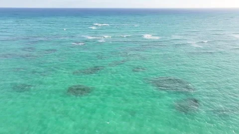 Drone over beautiful blue ocean waves with no land in sight on a clear blue sky Video stock 300595995