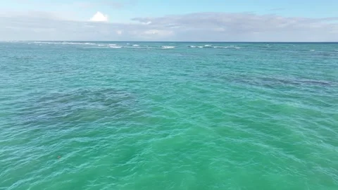 Drone over beautiful blue ocean waves with no land in sight on a clear blue sky Stock Footage 300596455