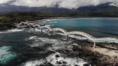 Drone over bridge between land at coastline HD 13 Stock Footage 129256909