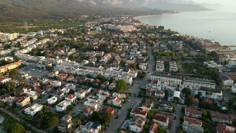 Drone over a city surrounded by mountains and sea at dawn, fog, summer day 4k Stock Footage 217887108