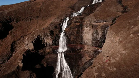 Drone over cliffs to flowing waterfall of rjukandafoss Stock Footage 166499943