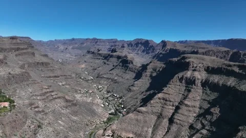 Drone Over Dramatic Volcanic Mountain Valley Under Blue Sky – Gran Canaria Stock Footage 309943572