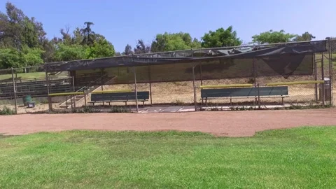 Drone over empty baseball field, empty dugout, empty stands Stock-Footage 136561645