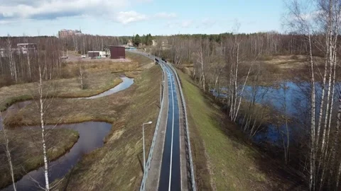 Drone over an Empty Bike Path After Rain the Sky is Reflected in Puddles Stock Footage 134275627