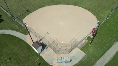 Drone over empty softball diamond while slowly tilting down Video stock 246566608