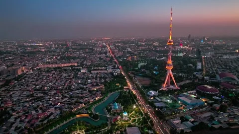 A drone over the evening streets of Tashkent against the backdrop of a sunset Stock Footage 310071337