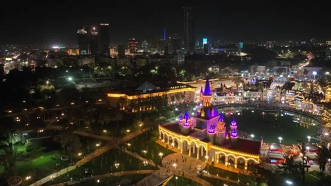 Drone over a face-to-face illuminated castle on the shore of a city lake Stock Footage 310237979