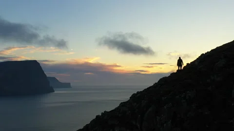 Drone Over Hiker At Sunset On Mount Villingadalsfjall Stock Footage 133580163