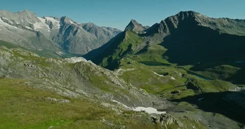 Drone Over Hiking Couple in Rugged Swiss Alps with Glaciers and Towering Stock Footage 342345197