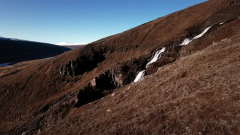 Drone over hillside to flowing waterfall of rjukandafoss Stock Footage 166499293
