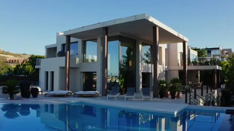 Drone Over Infinity Pool Towards Poolside Chairs Of Luxury Property Video stock 174332538