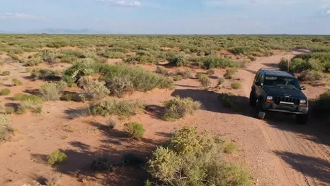 Drone over Jeep in desert Stock Footage 146136187