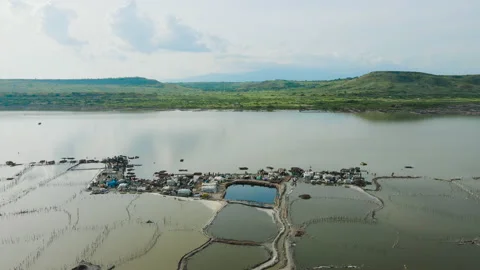Drone over Lake Katwe a Salt mining site with local workers Stock Footage 234876704