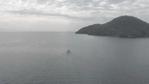 Drone over lake, moving backwards from catamaran Stock Footage 213928077