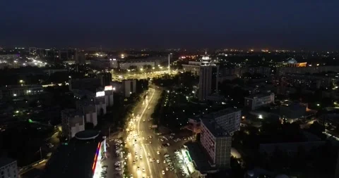 A drone over a lit city at night. A cloudless summer night. Stock Footage 334649738