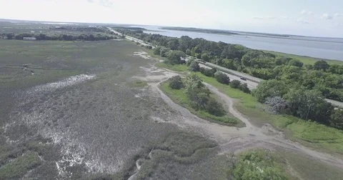 Drone Over Marsh and Highway Vídeos de archivo 83865101