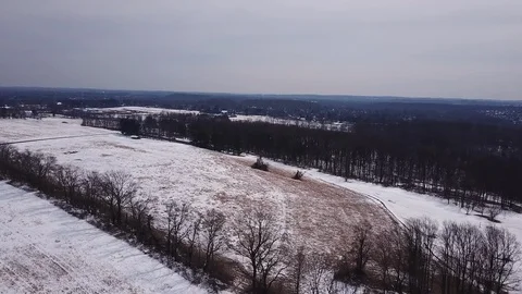 Drone over melted snow covered field 스톡 동영상 104307411