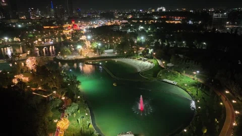 A drone over a nighttime illuminated city lake. Stock Footage 334936680