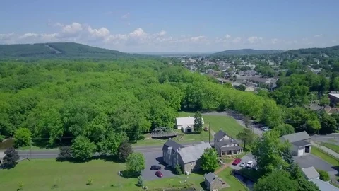 DRONE Over Park, Trees and Small Town Stock Footage 76851276