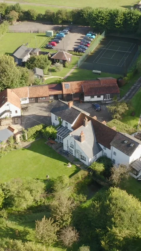 Drone over patchwork English fields and country roads 스톡 동영상 310605298