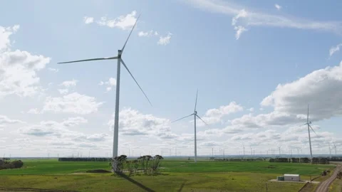 Drone Over Patterned Farmland and Wind Turbines Stock Footage 334267631